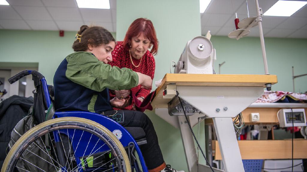 Georgia- woman on wheelchair learning how to sew